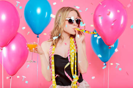 Gorgeous trendy young woman in party outfit celebrating birthday. Party mood, balloons, flying...