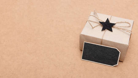 Happy Father's Day Background. Beautiful retro style gift box and black bow tie on brown background....