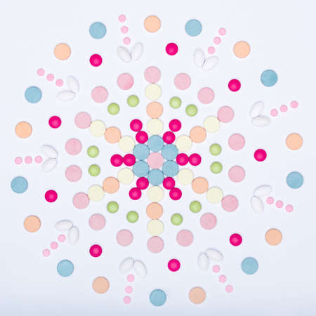 Assortment of various colourful pills on white background.  Creative medication and prescription...