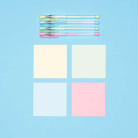 Creativity flat lay. Top view of set of sticky notes and colorful pens on pastel blue colored...