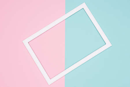 Abstract geometrical pastel blue, teal and pink paper flat lay background. Minimalism, geometry and symmetry template with empty picture frame mock up.の写真素材