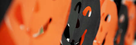 Festive Halloween pumpkins paper garland. Holidays, decorations and party concept banner.