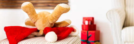 Merry Christmas banner. Soft toy teddy bear Christmas present. Christmas morning lifestyle...