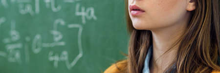 Teenager girl in math class overwhelmed by the math formula. Pressure, Education, Success concept.