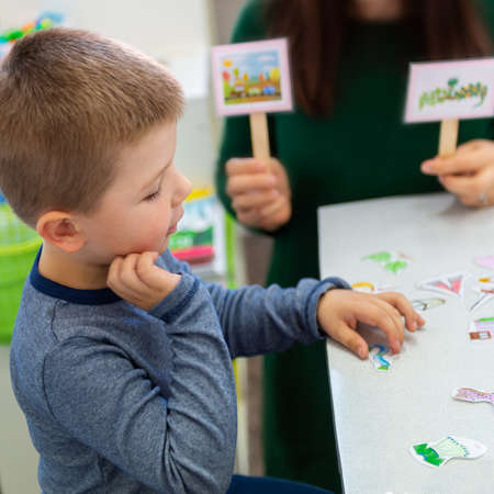 Young boy in speech therapy office. Preschooler exercising correct pronunciation with speech...