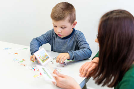 Young boy in speech therapy office. Preschooler exercising correct pronunciation with speech...