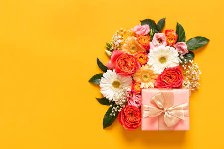 Happy Mother's Day, Women's Day, Valentine's Day or Birthday Pastel Candy Colors Background. Floral flat lay greeting card with beautifuly wrapped present and copy space.の写真素材