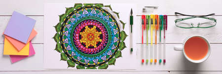 Adult coloring book, stress relieving trend. Art therapy, mental health, creativity and mindfulness concept. Flat lay web banner, panoramic close up shot.の写真素材