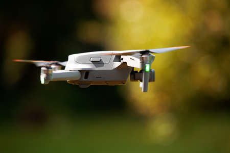 A flying drone. Airborne quadcopter. Also known as a drone or UAV, Unmanned Aerial Vehicle. Drone...