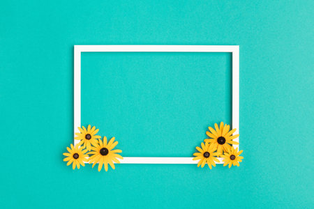 Happy Mother's Day, Women's Day, Valentine's Day or Birthday Pastel Blue Background. Turquoise colored flat lay greeting card template with beautiful flowers and empty picture frame.の写真素材
