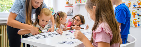 Child occupational therapy session. Group of children doing playful exercises with their therapist.