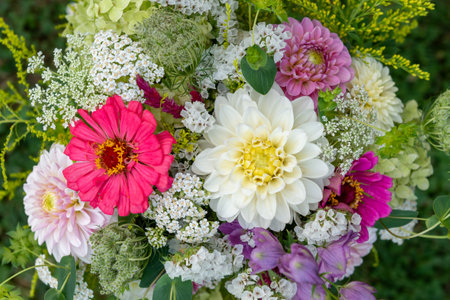 Summer bouquet top view.  Beautiful multi colored fresh flower arrangement. Birthday weddding bouquet photographed outdoors.の写真素材