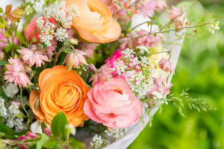 Spring mixed ranunculus bouquet. Beautiful pastel colored fresh flowers arrangement. Birthday bouquet made of ranunculus photographed outdoors.の写真素材