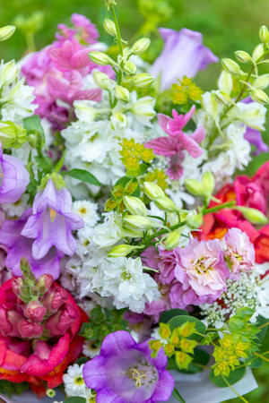 Flower bouquet made of mixed spring flowers. Beautiful pink and white fresh flowers arrangement. Birthday bouquet with snapdragons, matthiola and canterbury bells close up.の写真素材