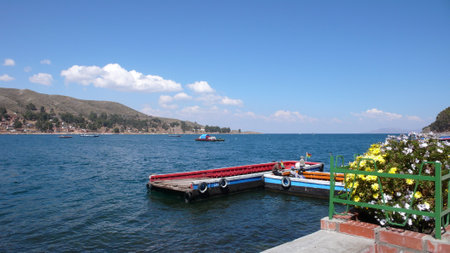 wooden Ferry over Titikaka lake blue sky flowersの写真素材