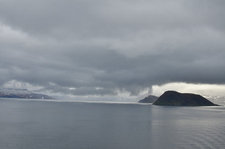 cloudy Fjord Norway ocean mirroring cold waterの写真素材