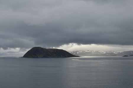 cloudy Fjord Norway ocean mirroring cold waterの写真素材