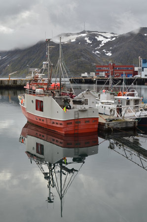 Harbour with smal fishing boats Norway rough cold wetの写真素材
