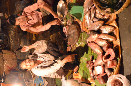 Fish shop at Night Market in Cambodia colorfull asian food womanの写真素材