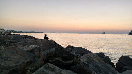 fishermen Angler sunset Paros Greece mediteranean island aegeanの写真素材