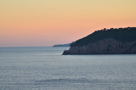 Sun is gone Dawn at Sea mountain silhouette colorfull Ocean Horizonの写真素材
