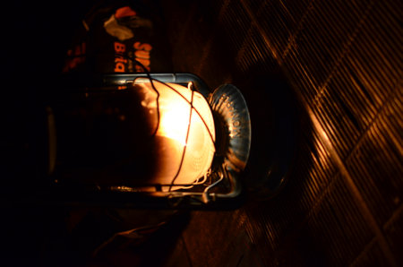Old kerosene oil petrolium lantern with warm yellow lightの写真素材