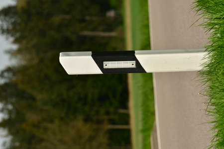 Delinator post on german country road green landscape. High quality photo