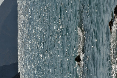 Waves hit rocks at shore Greek island of Kalymnos summer sun water. High quality 3d illustrationsの写真素材