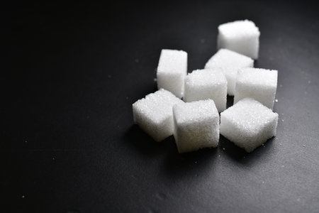 Sugar cubes black background background iluminated sweet food. High quality photoの写真素材