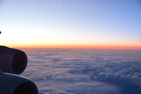 View of sunset from Airplane Window jet engine wing colorful. High quality photo