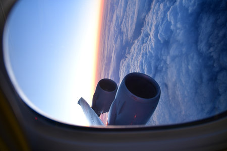 View of sunset from Airplane Window jet engine wing colorful. High quality photo