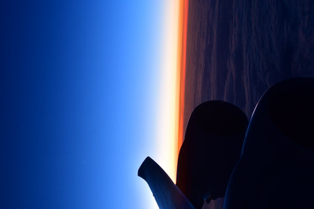 View of sunset from Airplane Window jet engine wing colorful. High quality photo