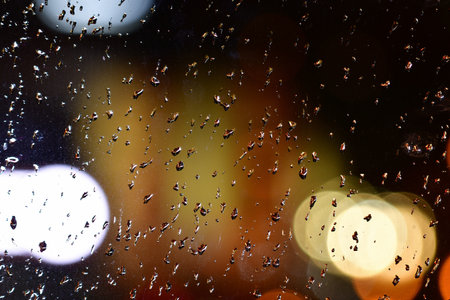 Rain drops on window blur night street wet . High quality photo
