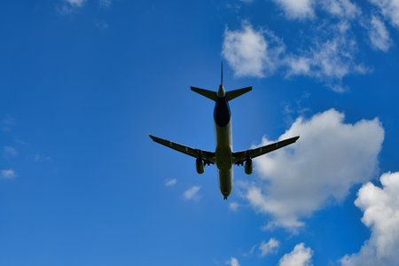 jet landing at Frankfurt Airport blue sky clouds. High quality photo