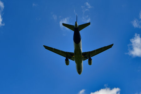 jet landing at Frankfurt Airport blue sky clouds. High quality photo