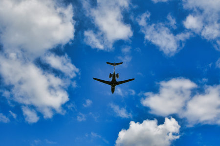 Business jet on blue sky with clouds from below. High quality photoの写真素材