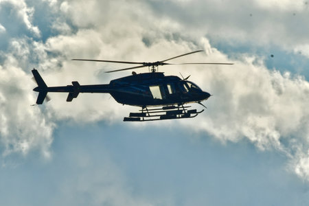 Helicopter in flight with cloud background sky. High quality photoの写真素材