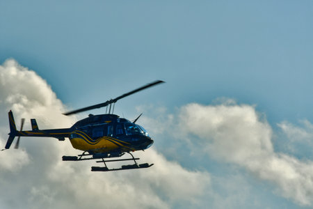 Helicopter in flight with cloud background sky transport. High quality photoの写真素材