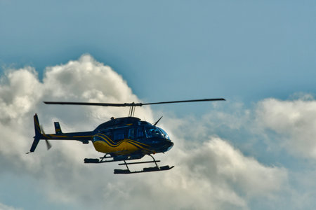 Helicopter in flight with cloud background sky transport. High quality photoの写真素材