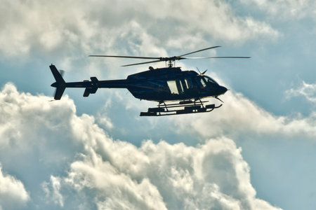 Helicopter in flight with cloud background sky transport. High quality photoの写真素材