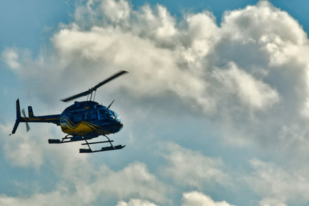 Helicopter in flight with cloud background sky transport. High quality photoの写真素材
