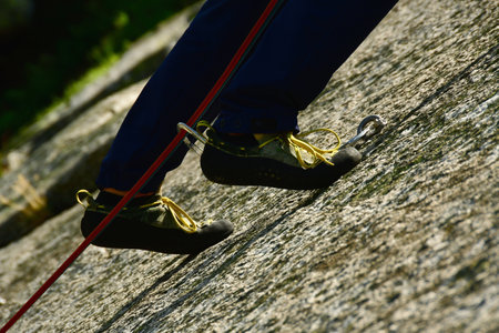 Rock climbing shoes with red pants summer outdoor friction rock. High quality photoの写真素材