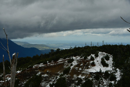 Puyehue winter ascent wet snow clouds forest ski adventure. High quality photoの写真素材