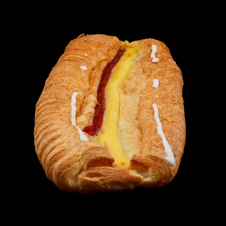 One large danish pastry isolated on black