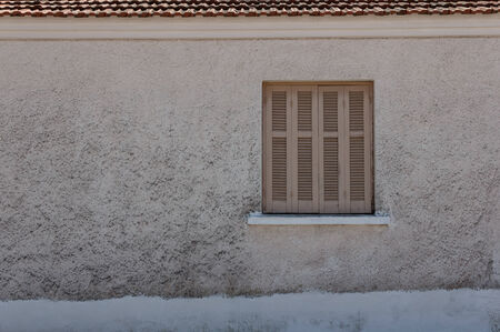 Closed window in Greece on gray wallのeditorial素材