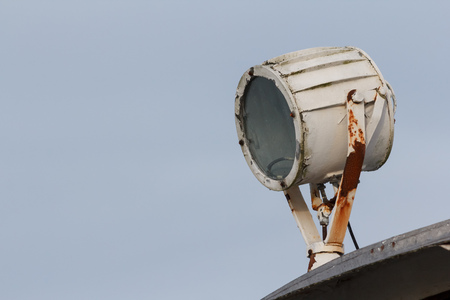 Marine signal light with rust on a boat used as a search light or signalingの写真素材