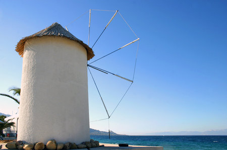 Cycladic type windmill by the sea.の写真素材