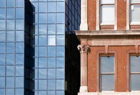 Two neighboring buildings detail - modern structural glazing confronted to traditional neoclassical elevationの写真素材