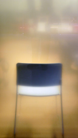 Blurred chair behind frosted glassの写真素材