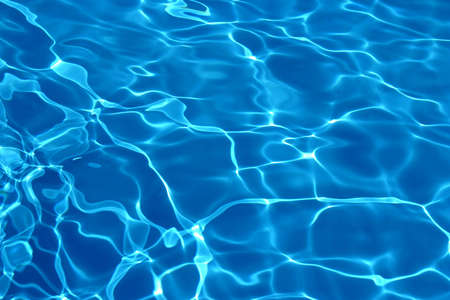Wavy blue pool water reflecting the sky